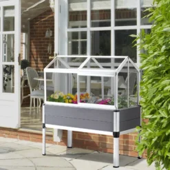 OUTSUNNY Mini Serre Sur Pieds Dim. 113L X 61l X 128H Cm - 4 Lucarnes, 2 Portes Coulissantes - Piètement Structure Alu. PVC Aspect Bois Gris Polycarbonate -Promos Jardin Noble Magasin 51254810 2